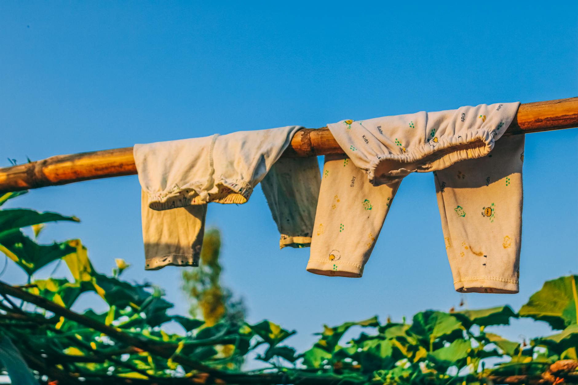 A drying-care visual with hanging clothes and fabric protection cues